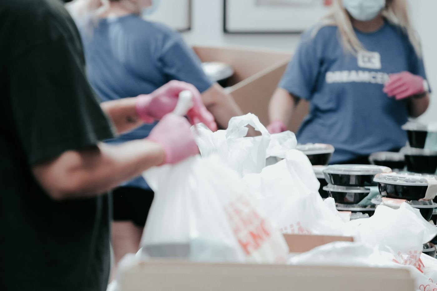 Volunteers packing food into bags for families