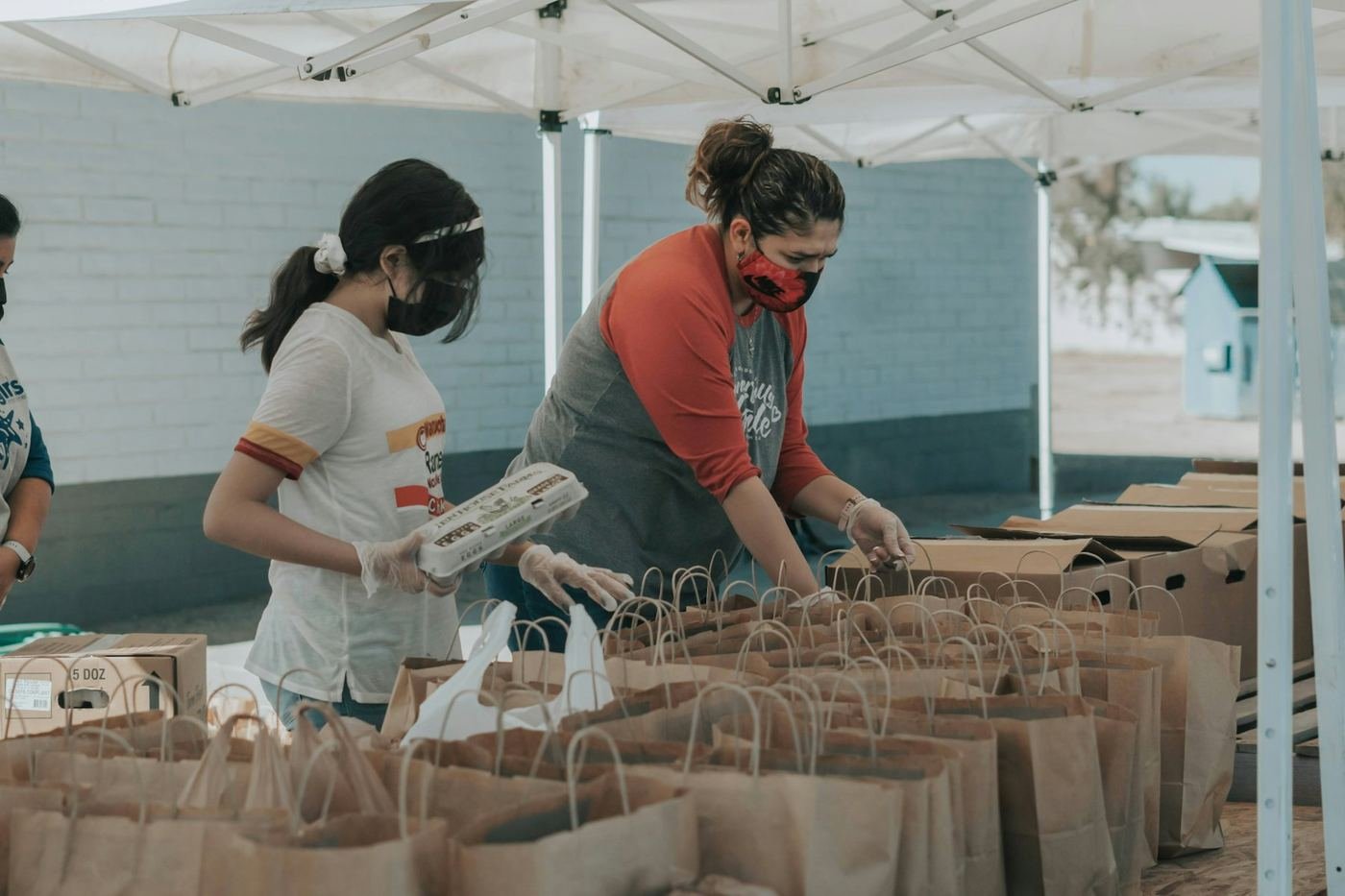Volunteers packing grocery bags for families