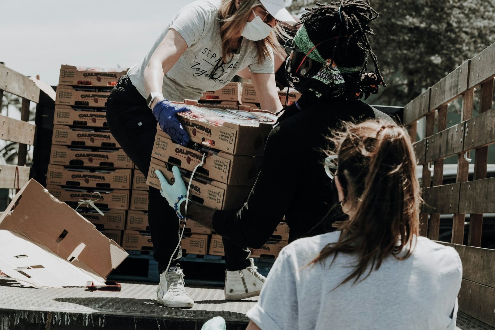 Volunteers loading boxes of fresh food for families