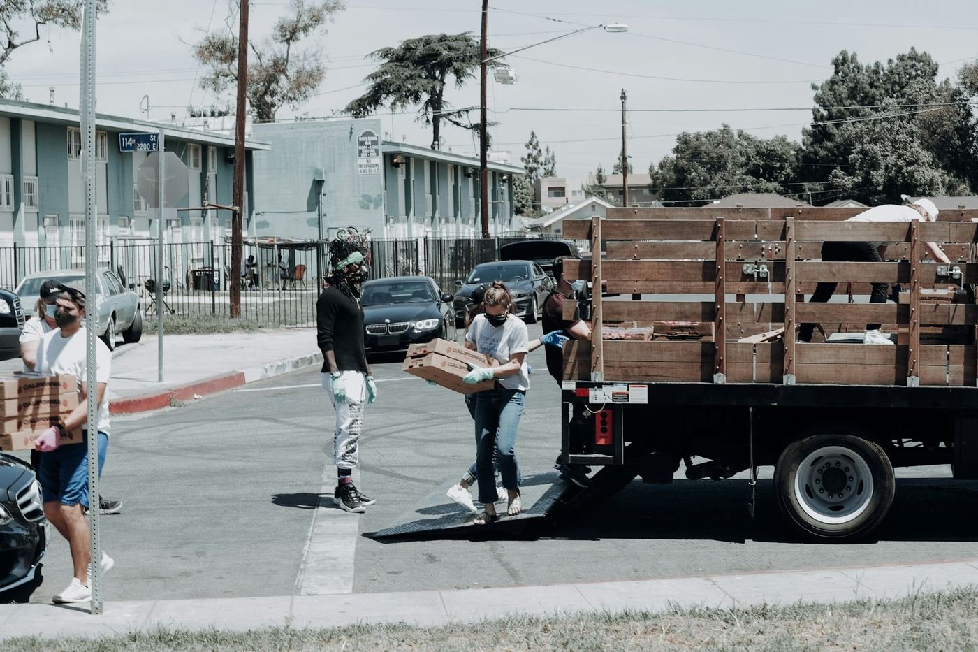 Volunteers unloading food boxes from a truck