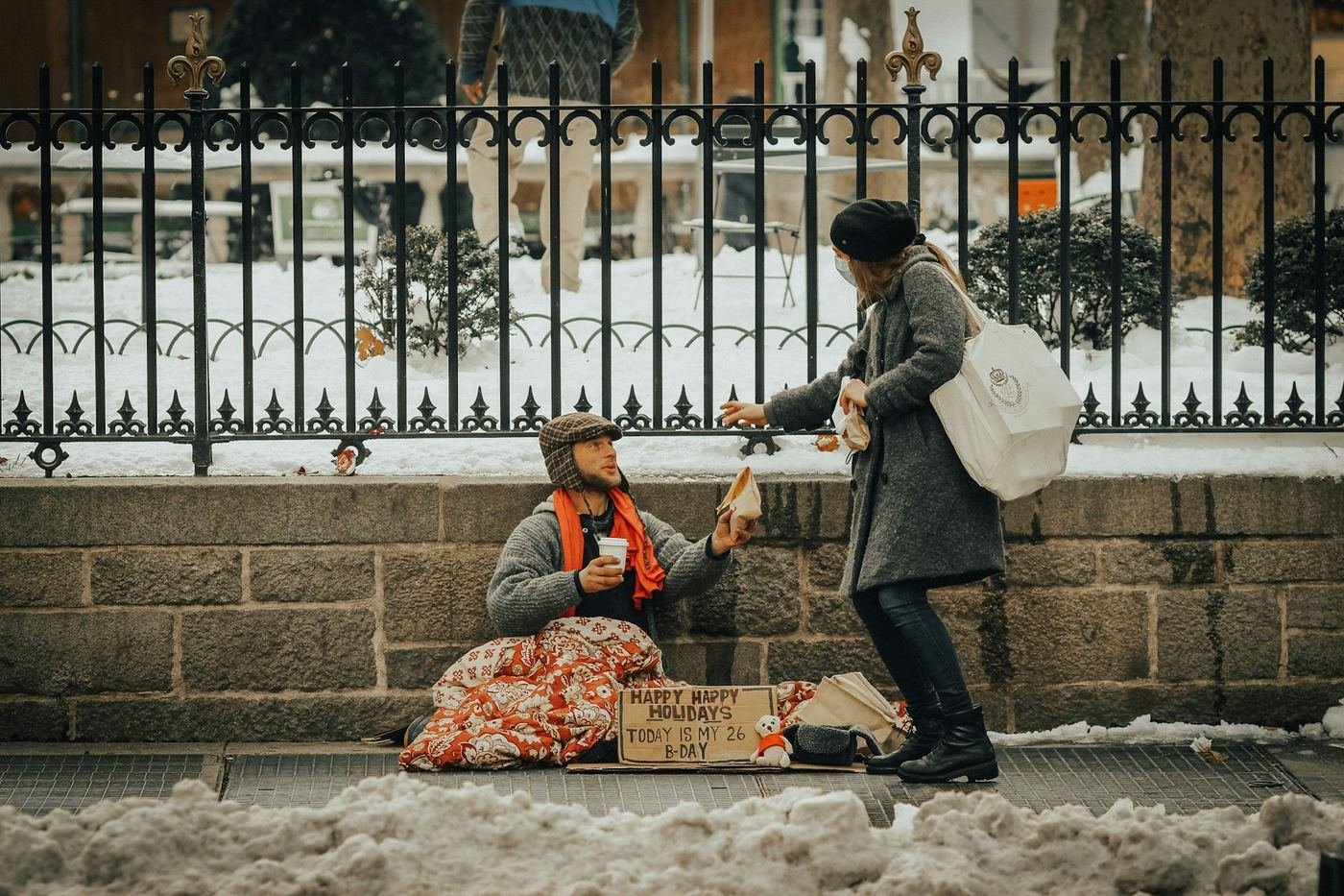 A woman offering help to a person on a snowy street